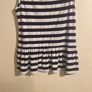 A black and white strip blouse with ruffles on the front right side